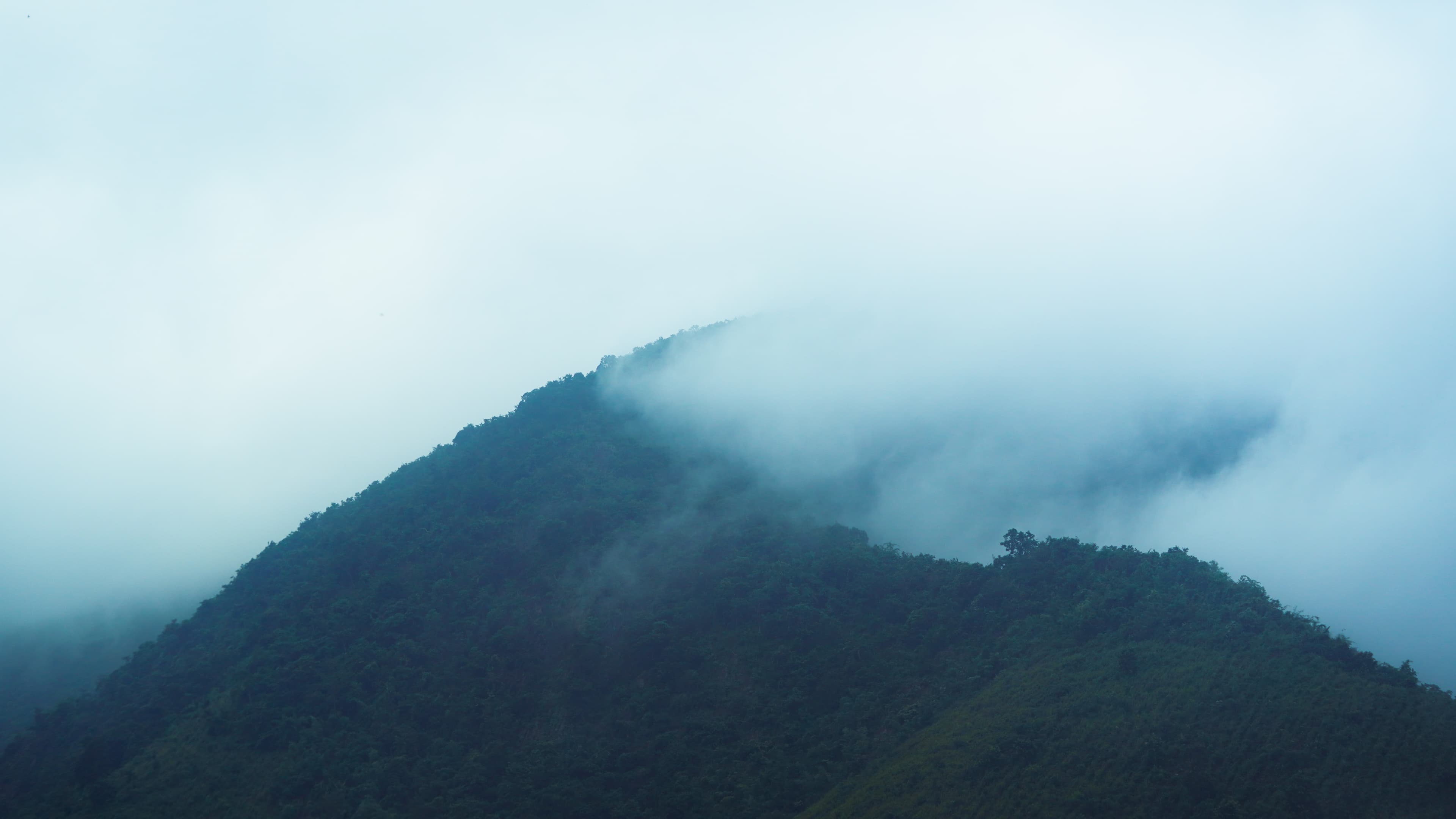 A breathtaking view of the misty mountains during sunrise